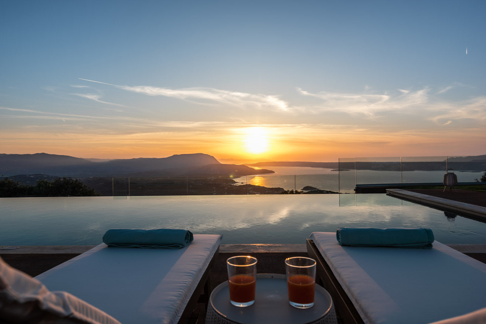 Sunset from the infinity pool, loungers facing the north coast