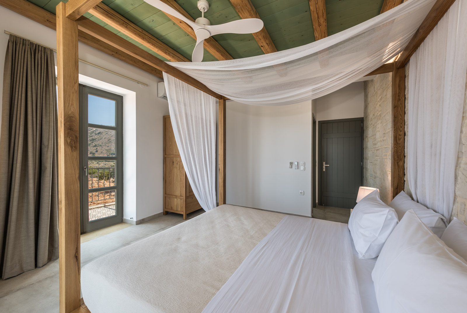 Four-poster double bedroom with sea-view balcony doors
