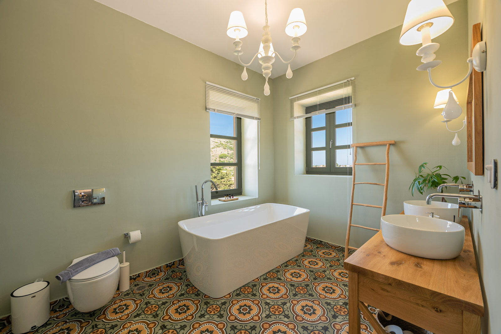 Ensuite bathroom with freestanding bathtub and double vessel sinks