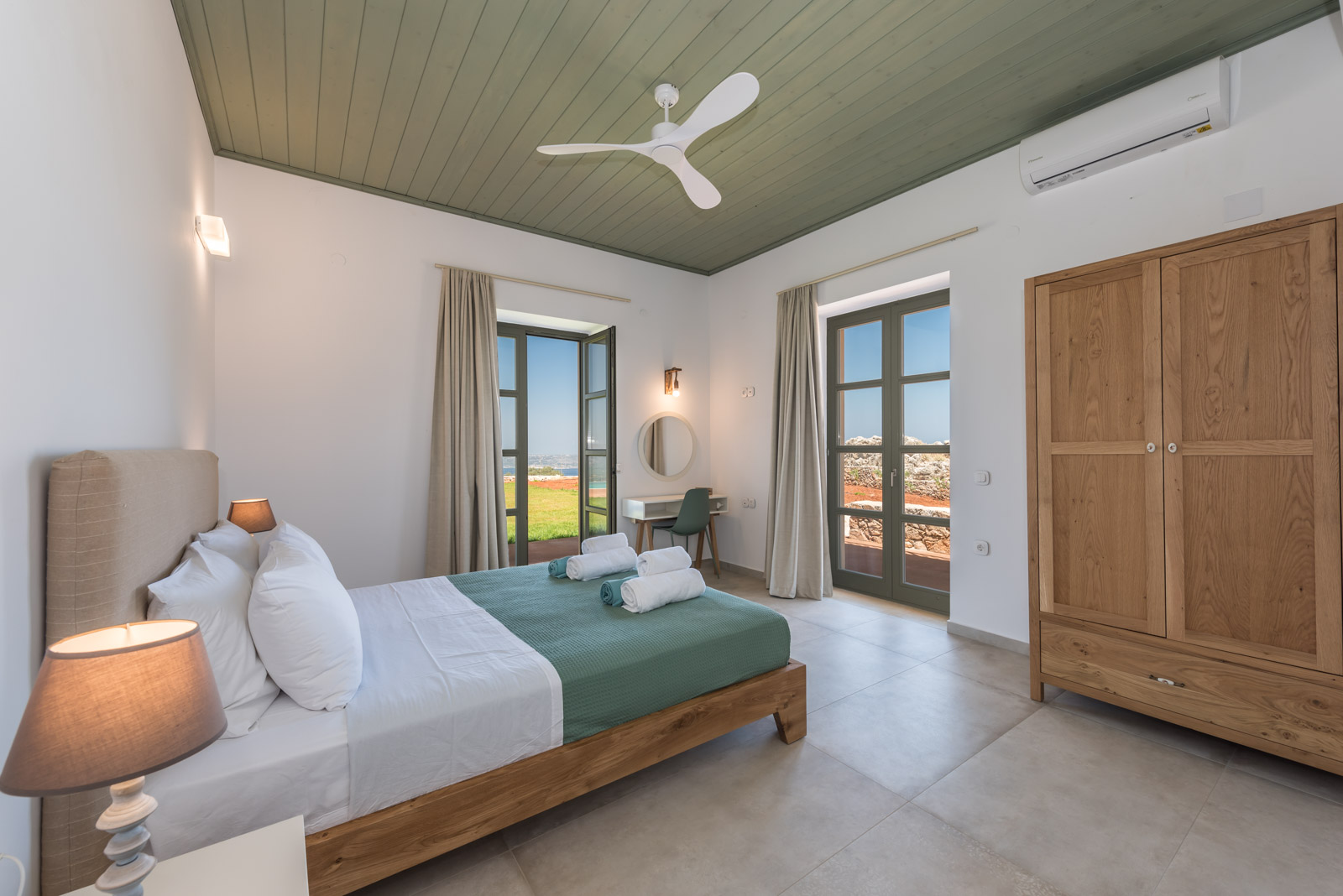 Ground-floor double bedroom with sage-green ceiling and garden doors